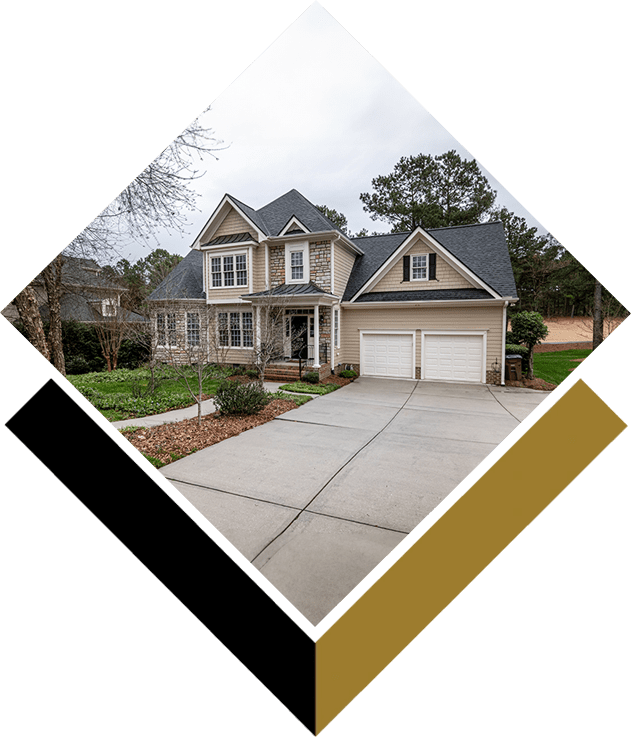 A house with two garage doors and a driveway.