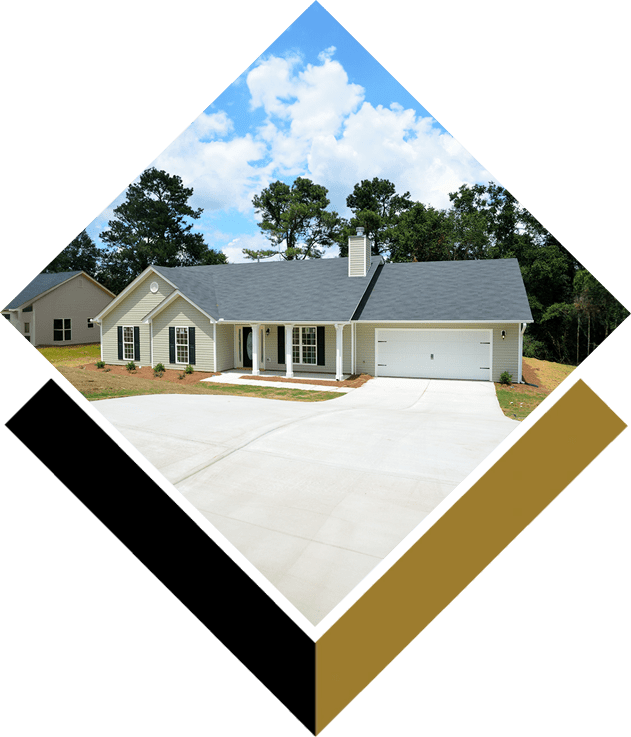 A house with a garage and trees in the background