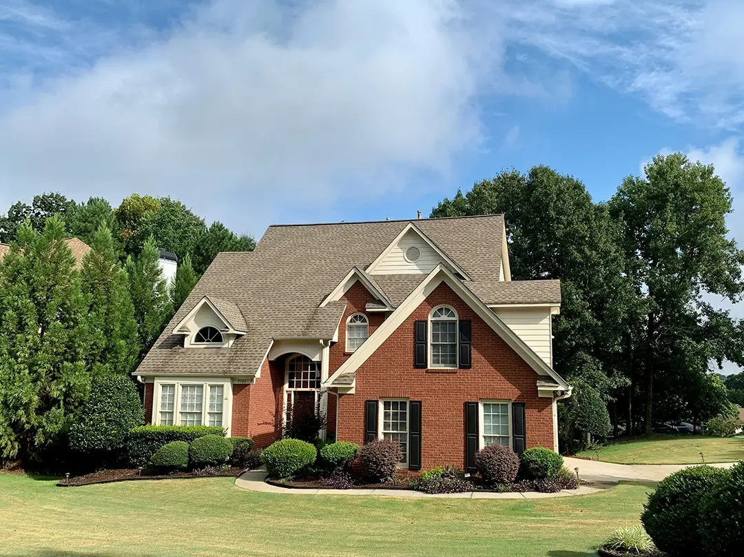 A large house with trees in the background