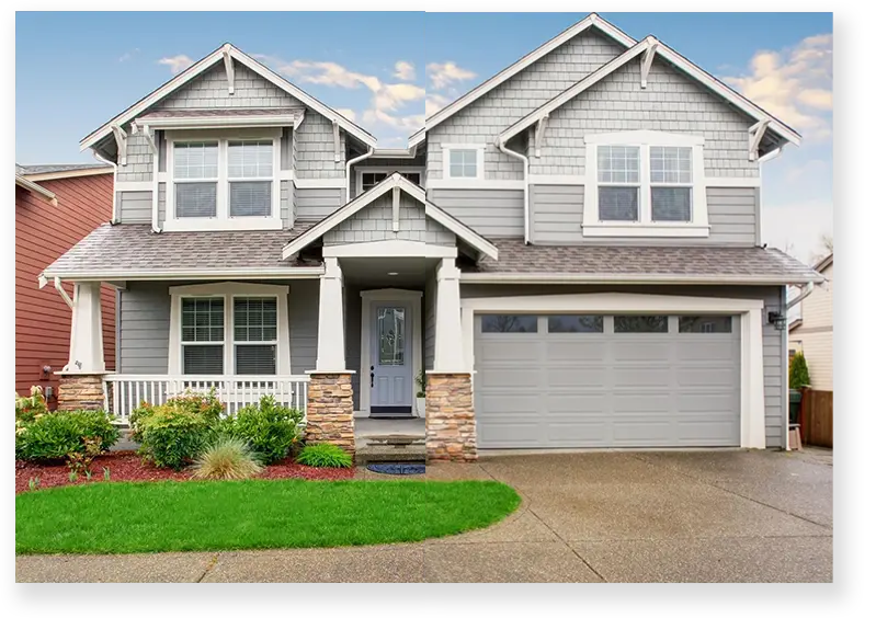 A house with a driveway and garage in front of it.